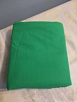 Folded green cotton cloth on table