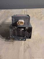 Front view of LG magnetron showing ceramic 2-pin connector and heatsink fins