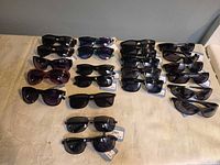 All sunglasses laid out in rows on table
