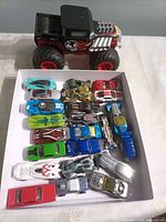 Top view showing monster truck and tray of die-cast cars