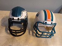 Front view of both mini helmet banks showing face masks and team colors