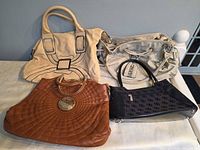 Four handbags front view showing colour and style