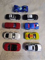Top view of nine Maisto cars in three-by-three layout