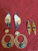 front view of all three earring pairs on red fabric