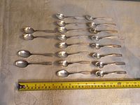All 20 spoons laid out with tape measure for scale