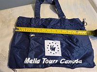 Front view of tote bag with tape showing width