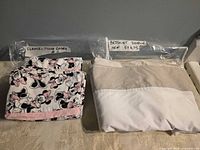 Folded Minnie Mouse pillowcases and packaged bedskirt side by side