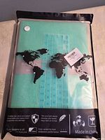 Front of packaged mint green MacBook case showing color and keyboard skin