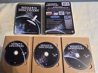Open steelbook showing three Mission Discovery discs seated in cardboard tray