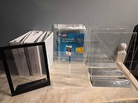 Group view showing binders, floating frame, sealed Staples sign holders, brochure rack, upright sign holders