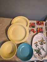 Overview of all items: melamine plates and bowls, Villeroy & Boch platter, Canada magnets and keychain
