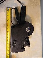 Left side view of Monarch 3721-AB price gun with tape measure for size reference