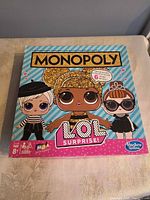 Front of Monopoly LOL Surprise Edition box showing characters and branding