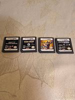 Front view of four Nintendo DS cartridges showing titles Fantastic Four, Star Wars, Iron Man, Transformers