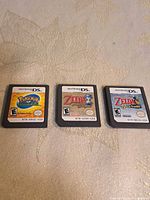 Three Nintendo DS cartridges laid out side-by-side: Pokémon Ranger, The Legend of Zelda: Phantom Hourglass, The Legend of Zelda: Spirit Tracks