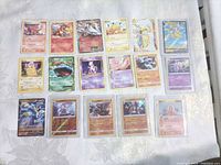Overview of all 17 Pokémon cards laid out on table