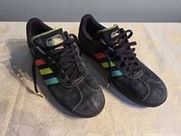 Overall view of both sneakers showing suede uppers and stripe colours