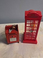 Front view of both coin banks showing styles and relative sizes