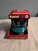 Helmet in box front view showing Mariners logo