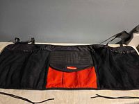 Full view of organizer laid flat showing overall design and straps