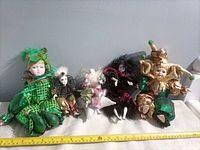 group shot of all five dolls with measuring tape