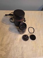 Lens, caps, filter ring, carrying case overview