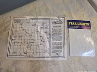 Packaged glow-in-the-dark star stickers next to unfolded instruction sheet
