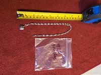 Full view showing chain length with measuring tape and heart locket