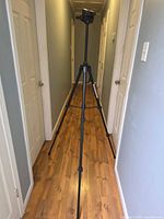 Tripod fully extended in hallway