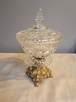 Full view of compote with lid on ornate brass base