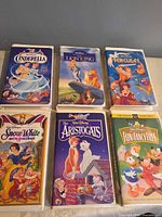 Front covers of six Disney clamshell VHS tapes