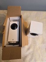 Both Wyze Cam Pan cameras, one in original foam packing, showing overall condition