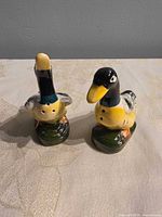 Front view of two ceramic duck shakers
