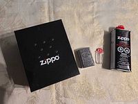 Full view of lighter, fluid can, flint dispenser and box