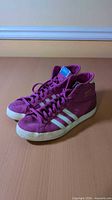Side view of both Adidas Basket Profi sneakers