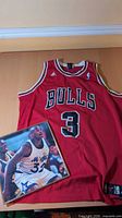 Front view of red Bulls #3 jersey laid flat