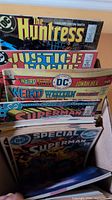 Box showing The Huntress, Justice League, Weird Western/Jonah Hex, Superman issues