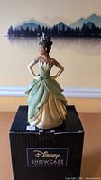 Front view of Princess Tiana figurine on top of branded box