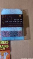 Boxed Aroma Home sherpa hand warmer showing label and fleece cover