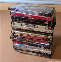 Stacked DVDs showing titles from Premonition down to Pushing Tin