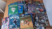 Spread of magazines showing Beckett guides, Sports Illustrated, Sportsnet Year in Sports, Baseball Hall of Fame book