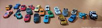 Full lineup of approximately 24 die-cast vehicles on table