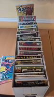 Long comic box filled with bagged comics