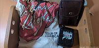 T-shirt, pouch, wallet inside wooden crate
