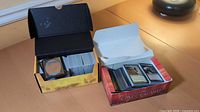 Two boxes of Magic: The Gathering cards on a table