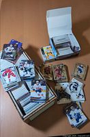 Open cardboard box and stacks of assorted hockey trading cards on table