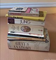 Stack of eight books showing titles and formats