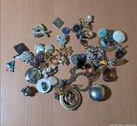 Full view of all mixed-metal jewelry pieces on surface