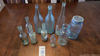 Full lot overview showing all ten glass containers on table
