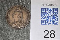 Obverse of coin beside reference card